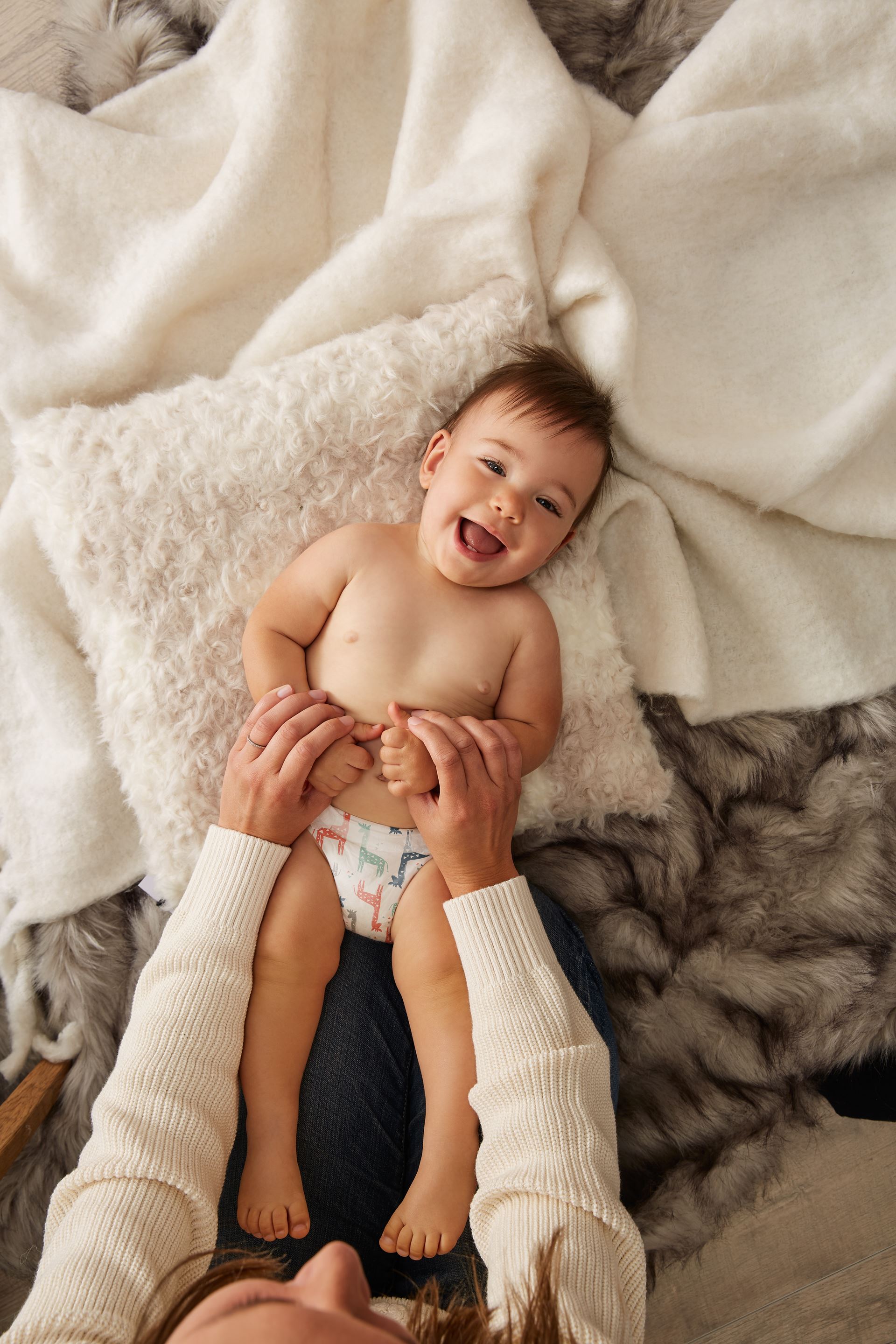 a hand holding a baby